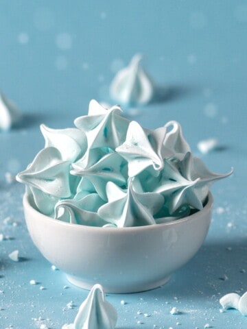 Blue meringue cookies on a white bowl