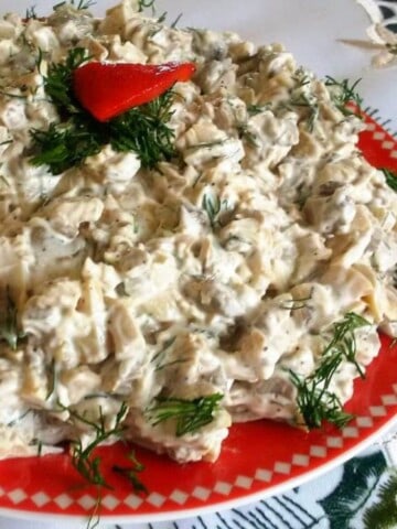 mushrooms salad with garlic and mayo on a red plate