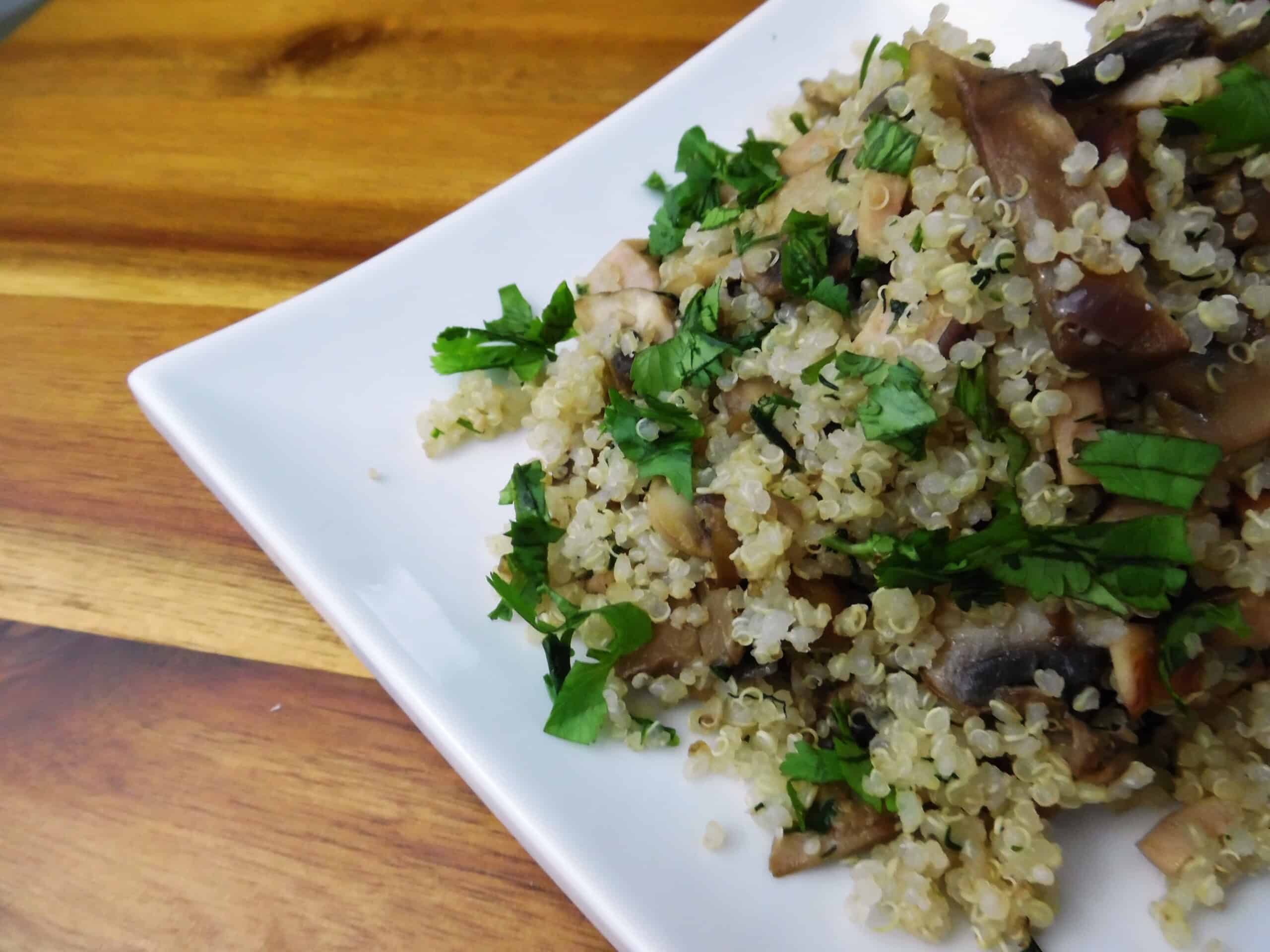 Easy Quinoa mushrooms salad with garlic and parsley on a white plate